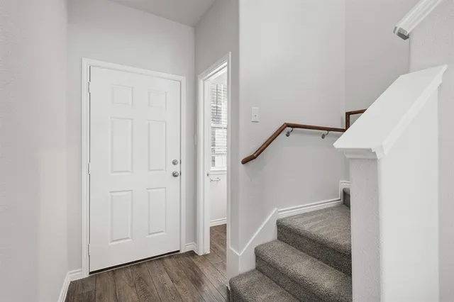 a living room with furniture and stairs