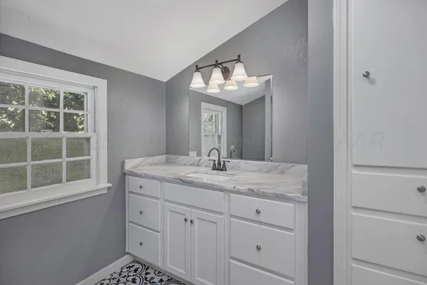a bathroom with a sink and a mirror