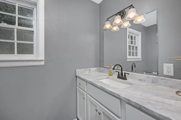 a bathroom with a sink and a mirror