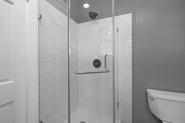 a bathroom with a shower and toilet