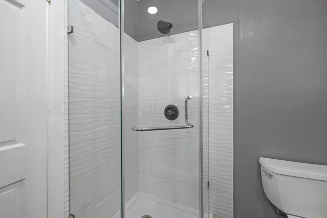 a bathroom with a shower and toilet