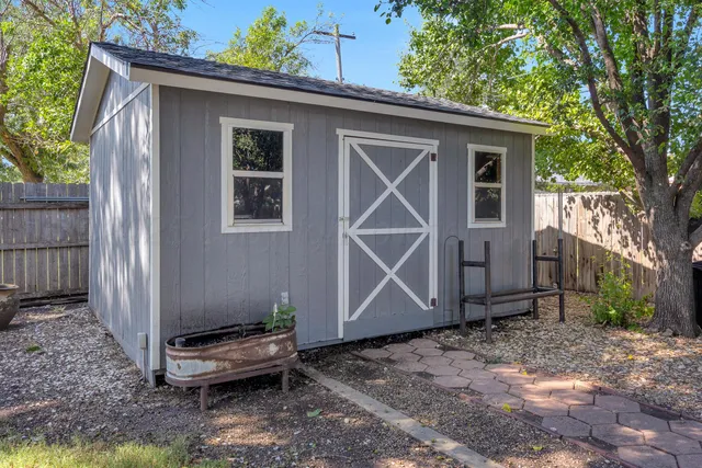 a backyard of a house with barbeque oven