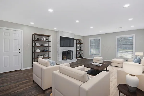 a living room with furniture a fireplace and a flat screen tv