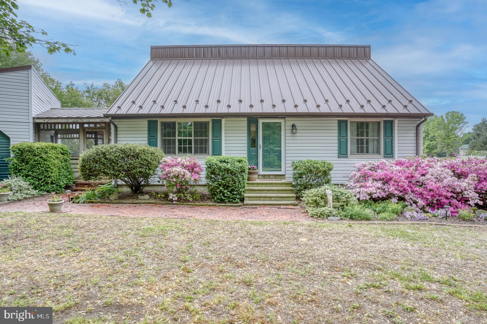 a front view of a house with a garden