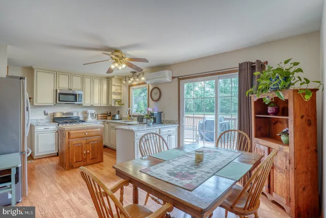 a kitchen with stainless steel appliances granite countertop a stove refrigerator and cabinets