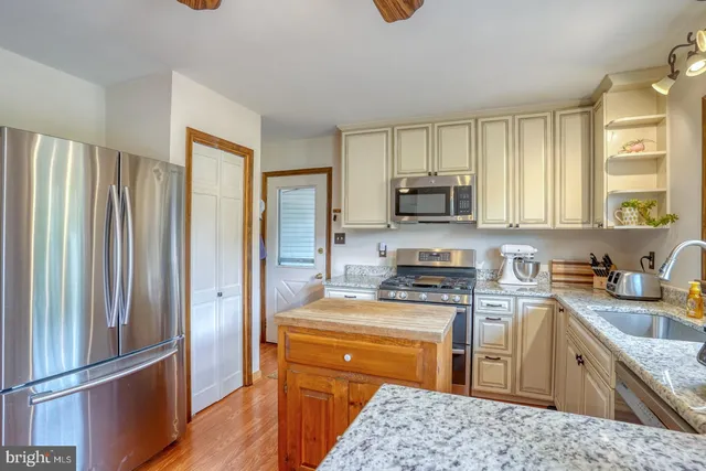 a living room with furniture a dining table and a chandelier