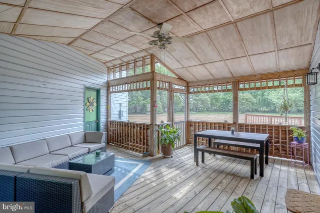 a view of a patio with table and chairs potted plants with wooden floor