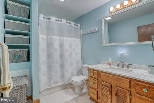 a bedroom with a bed window and a ceiling fan