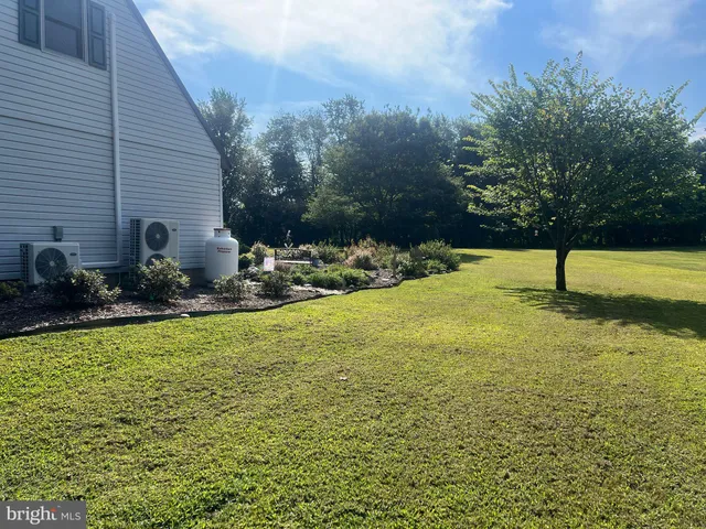 an aerial view of a house with a yard basket ball court and outdoor seating