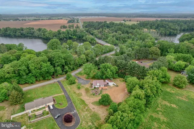 an aerial view of a house with a yard and lake view