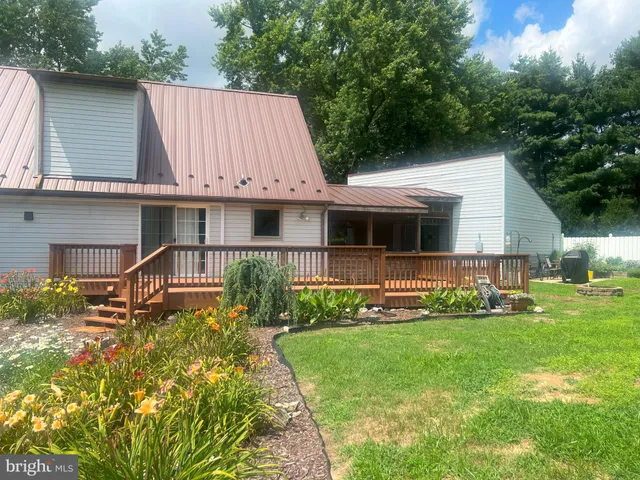 a view of a chair and table in the backyard