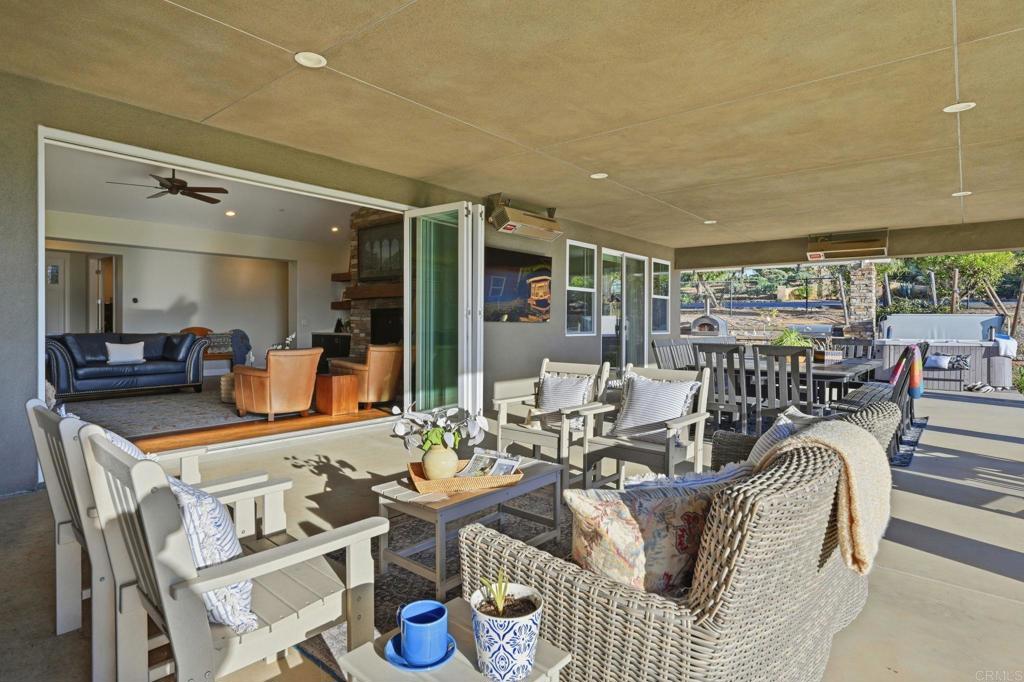 2263 Corner Creek Lane Fallbrook, CA 92028 - Photo 21 of 73 a dining room with furniture a rug and a large mirror