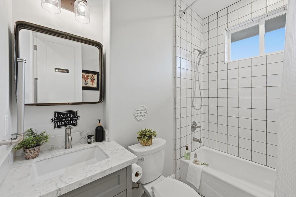 2263 Corner Creek Lane Fallbrook, CA 92028 - Photo 38 of 73 a bathroom with a sink mirror toilet and bathtub