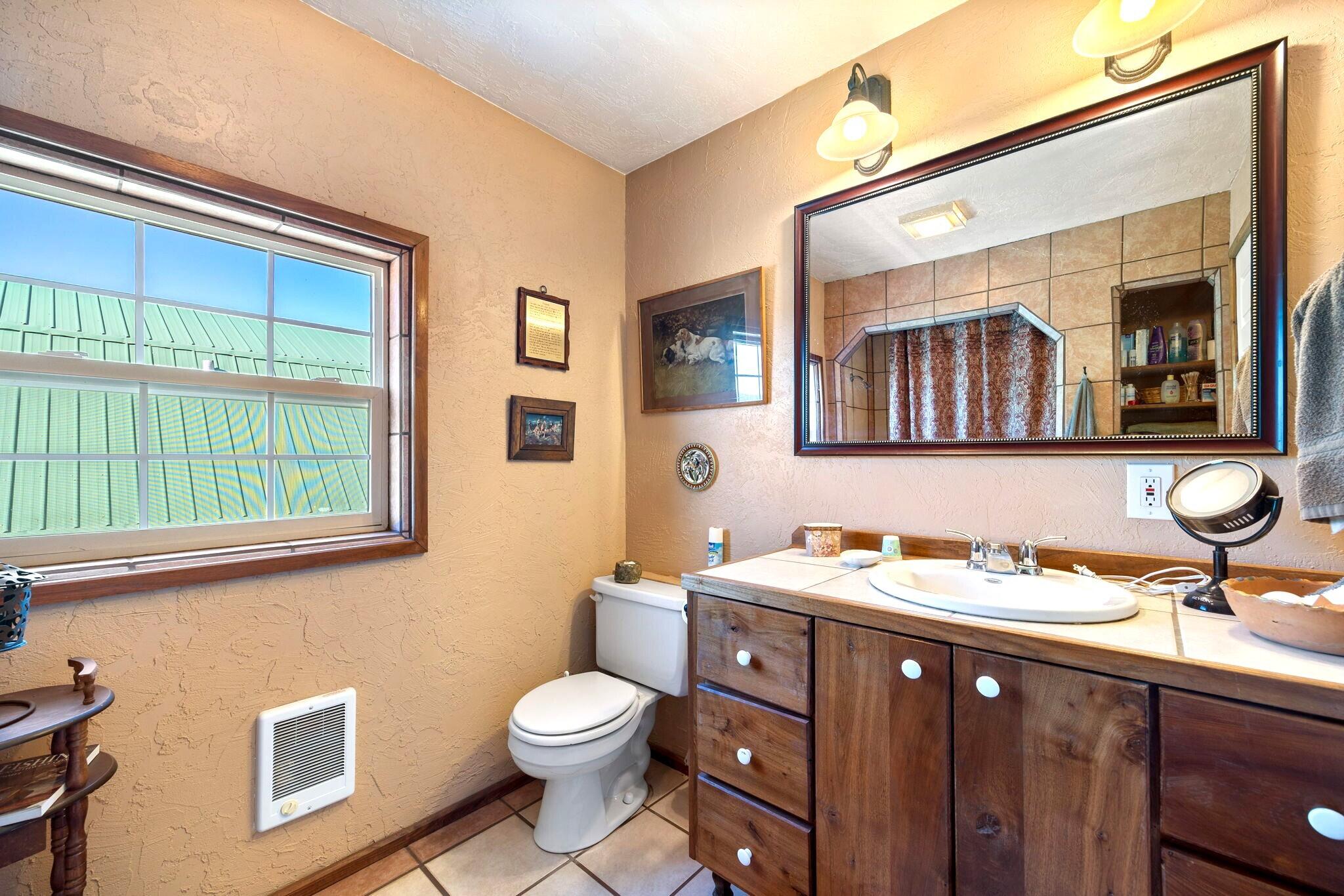 624 Baker Ranch Road Young, AZ 85554 - Photo 26 of 116 a bathroom with a toilet sink and mirror