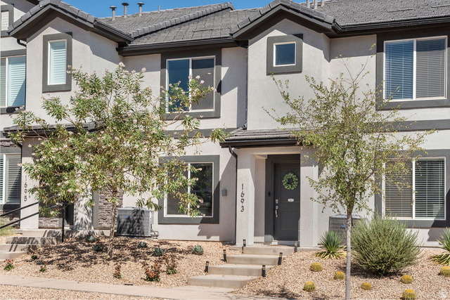 1693 Devils Gdn Lane Washington, UT 84780 - Photo 35 of 64 Contemporary townhome exterior featuring light stucco siding and dark trim