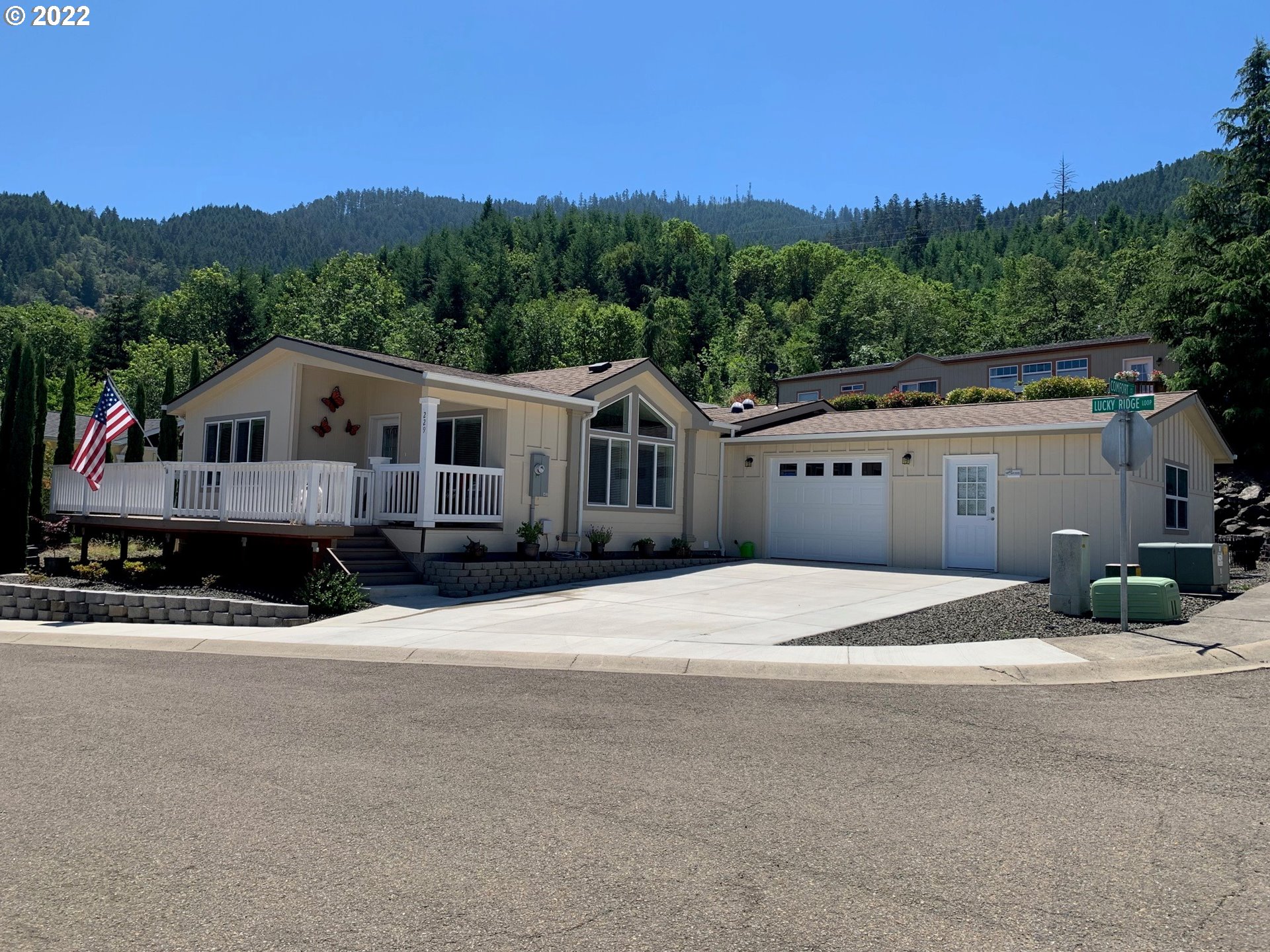 229 Lucky Ridge Loop Canyonville, OR 97417 - Photo 1 of 32 a front view of a house with a yard and garage