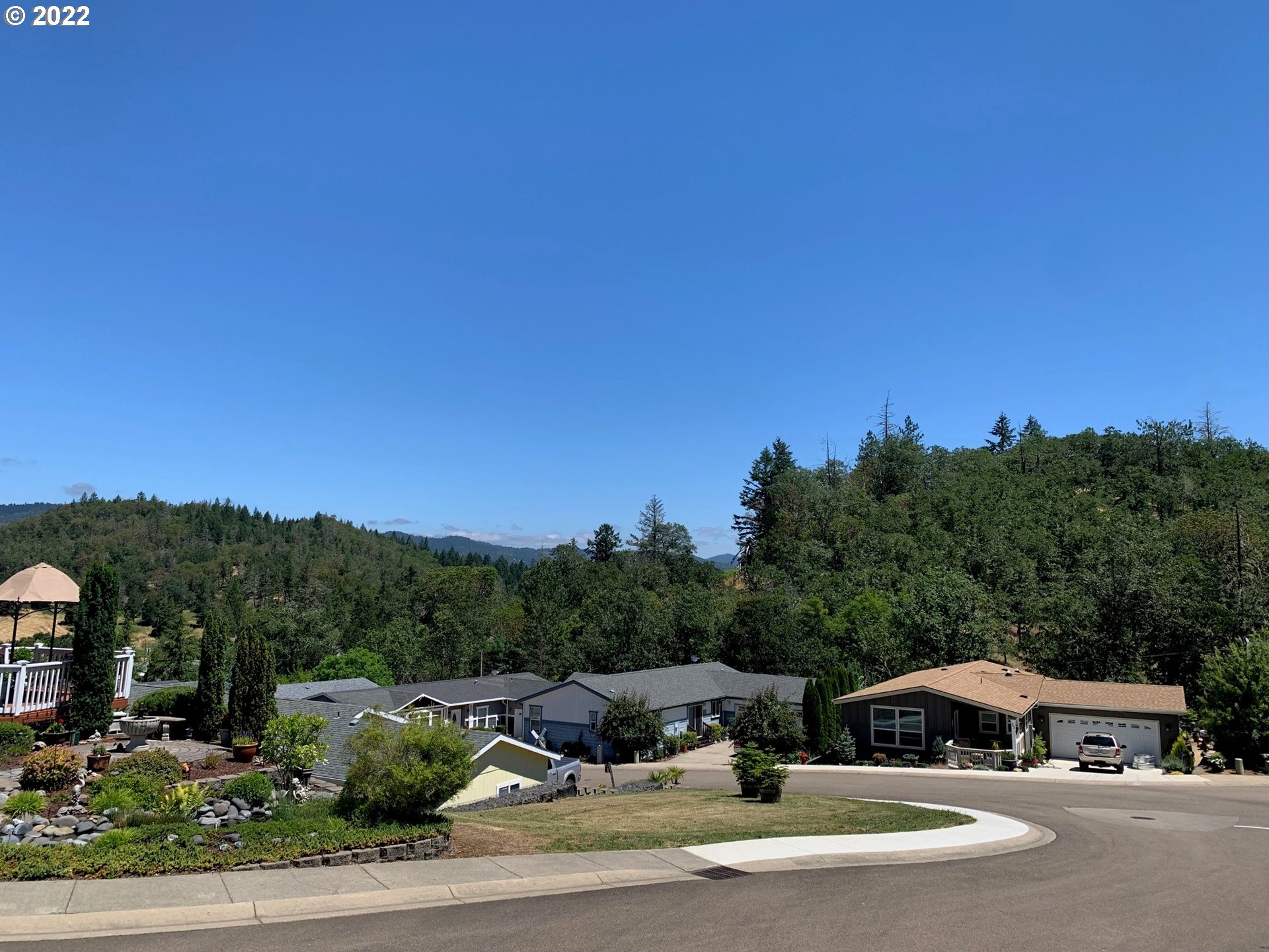 229 Lucky Ridge Loop Canyonville, OR 97417 - Photo 3 of 32 a view of a street with houses on the road