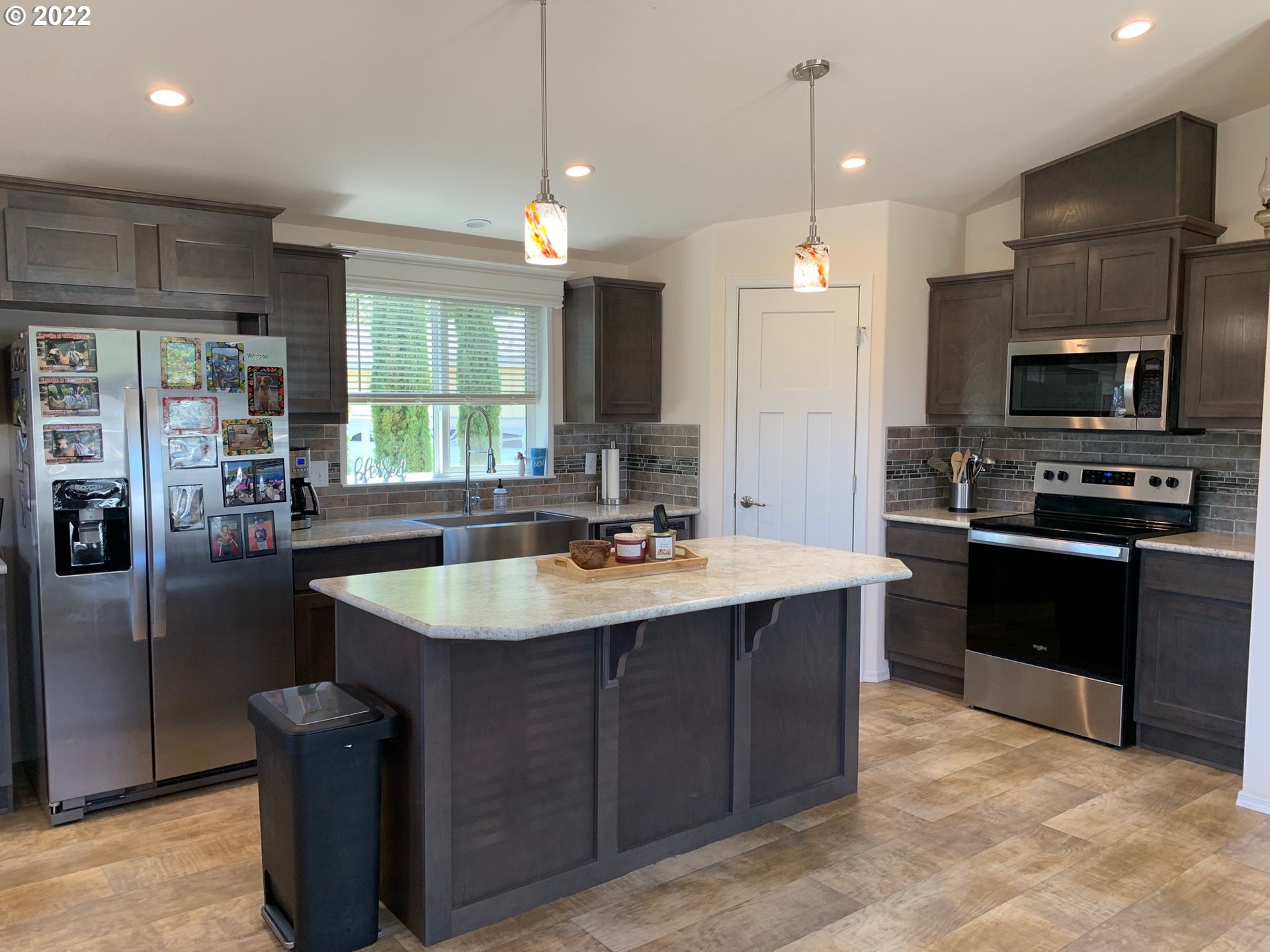 229 Lucky Ridge Loop Canyonville, OR 97417 - Photo 9 of 32 a kitchen with stainless steel appliances granite countertop a sink a stove and a refrigerator