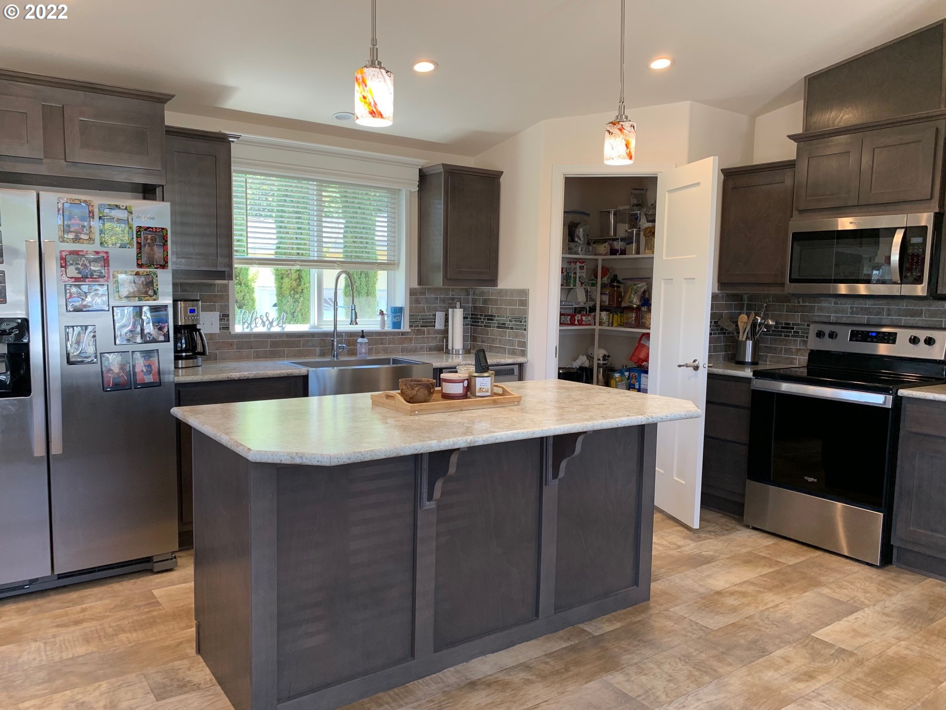229 Lucky Ridge Loop Canyonville, OR 97417 - Photo 10 of 32 a kitchen with stainless steel appliances granite countertop a sink a stove and a refrigerator