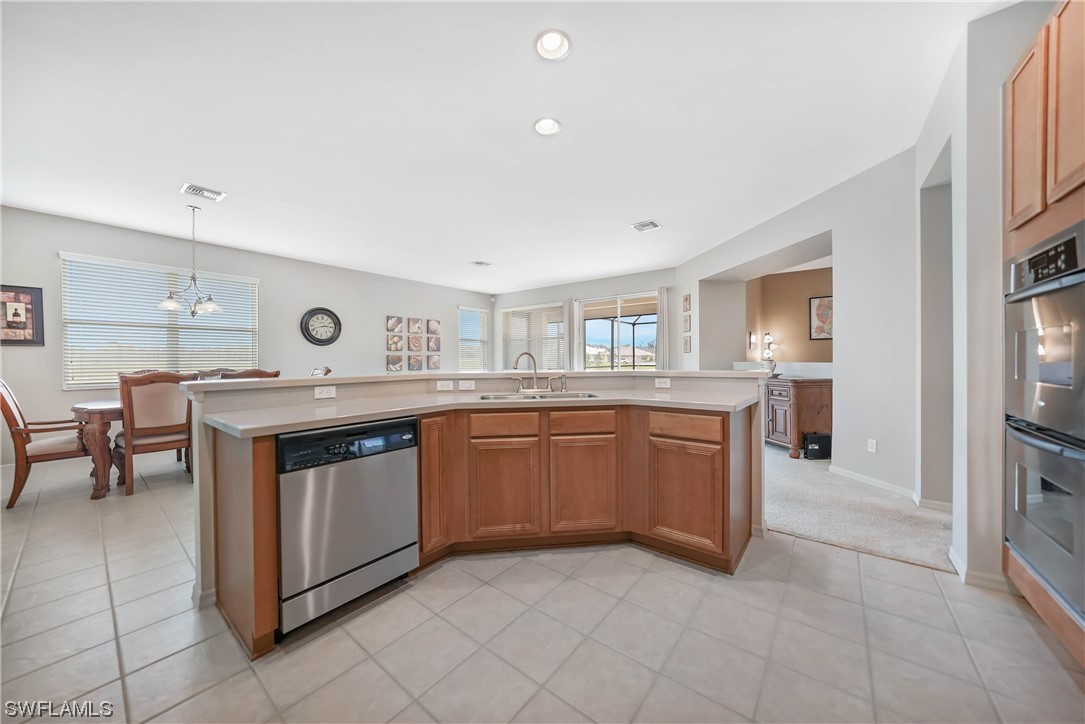 24501 Cabana Road Punta Gorda, FL 33955 - Photo 11 of 39 a kitchen with stainless steel appliances granite countertop a stove and a sink