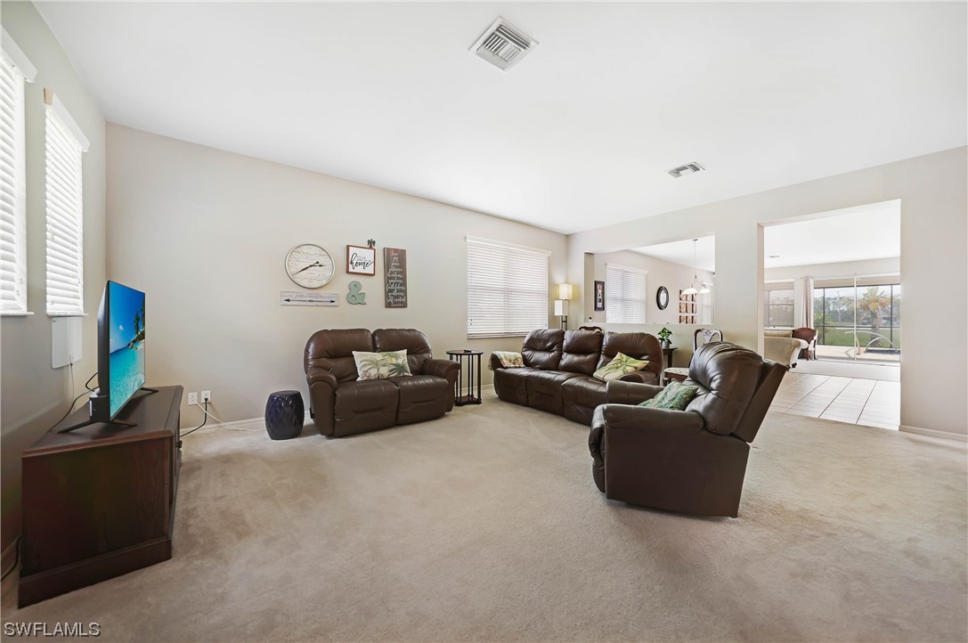 24501 Cabana Road Punta Gorda, FL 33955 - Photo 2 of 39 a living room with furniture and a flat screen tv