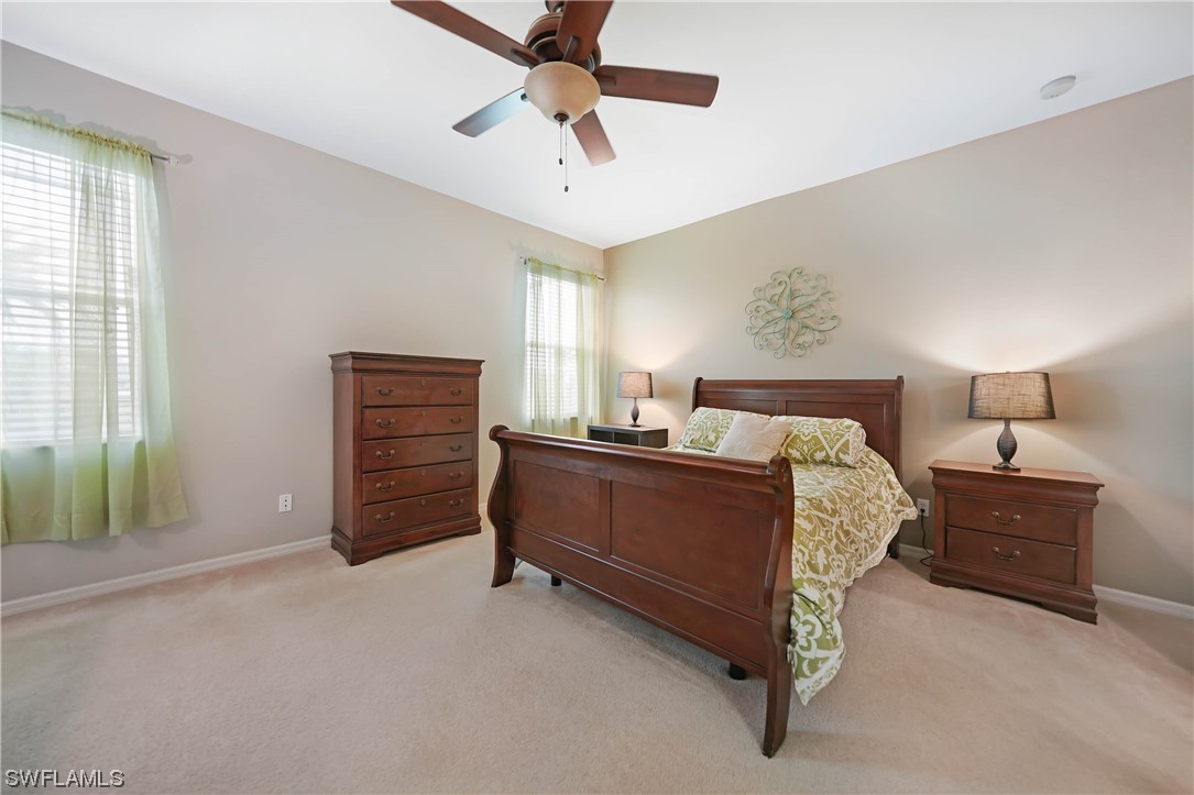 24501 Cabana Road Punta Gorda, FL 33955 - Photo 22 of 39 a bed room with a bed and a ceiling fan
