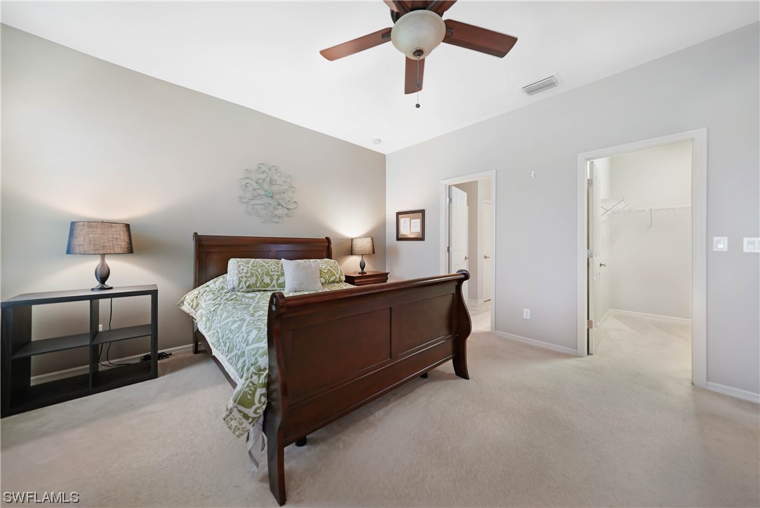 24501 Cabana Road Punta Gorda, FL 33955 - Photo 23 of 39 a bed room with a bed and a lamp
