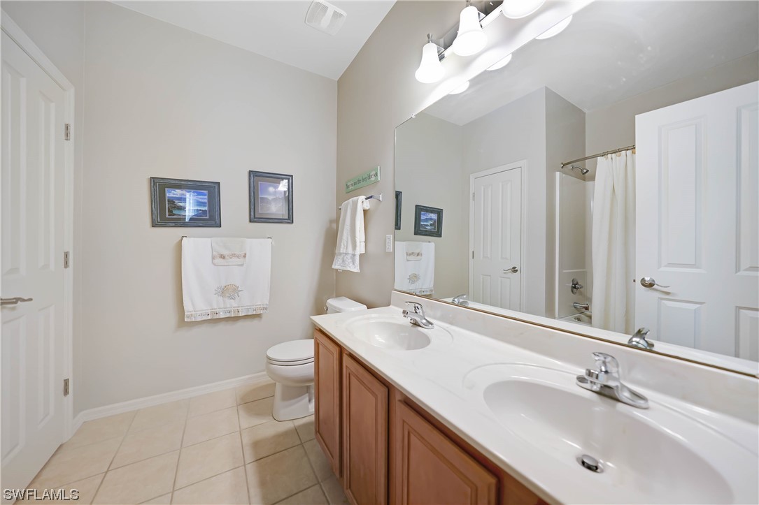 24501 Cabana Road Punta Gorda, FL 33955 - Photo 24 of 39 a bathroom with a double vanity sink mirror and toilet