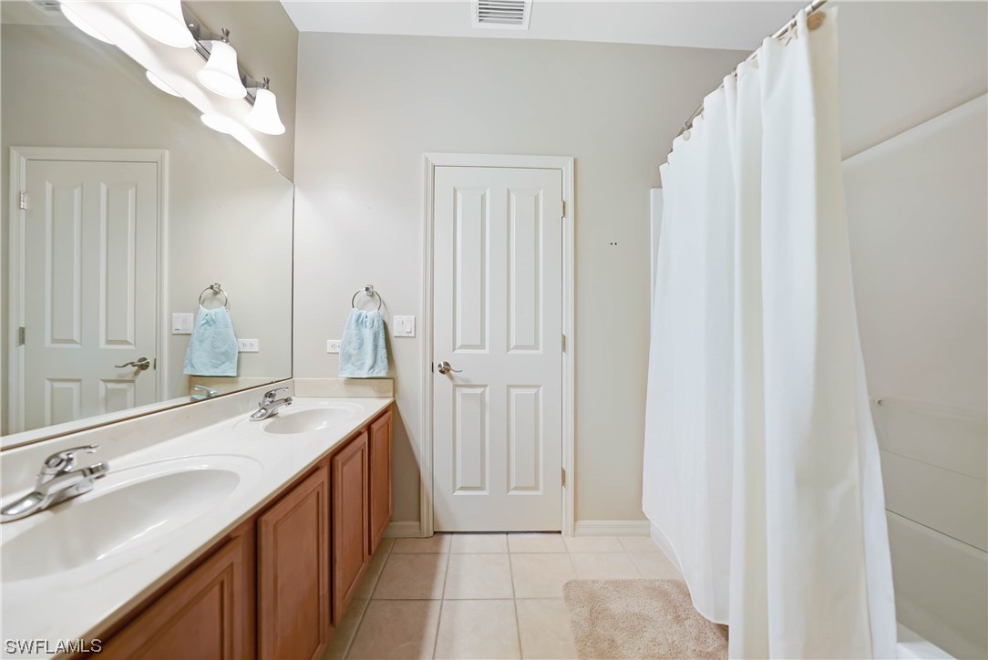 24501 Cabana Road Punta Gorda, FL 33955 - Photo 25 of 39 a spacious bathroom with a double vanity sink and a mirror