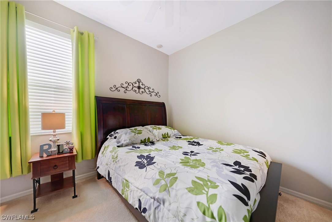 24501 Cabana Road Punta Gorda, FL 33955 - Photo 27 of 39 a bedroom with a bed and a table in it