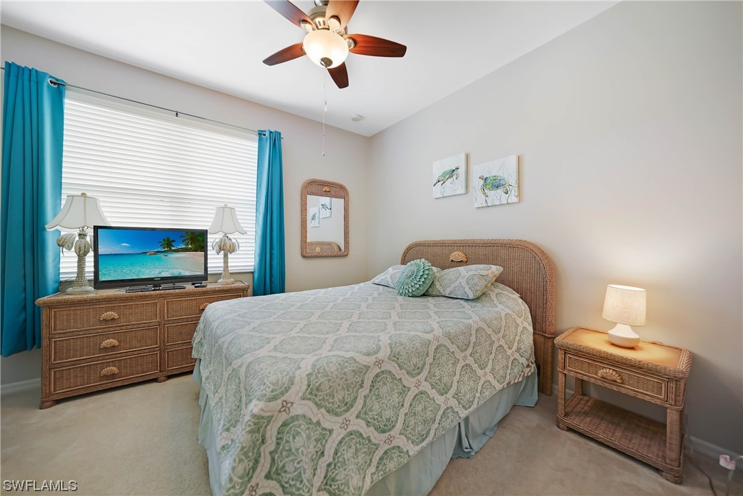 24501 Cabana Road Punta Gorda, FL 33955 - Photo 29 of 39 a bedroom with a bed and a chandelier