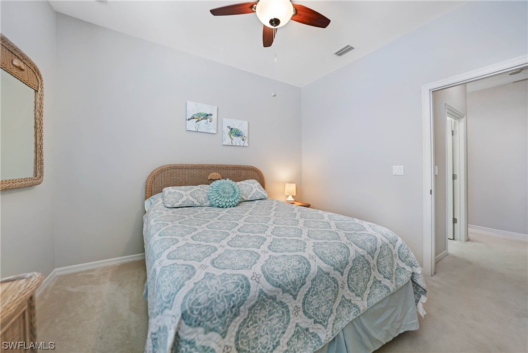24501 Cabana Road Punta Gorda, FL 33955 - Photo 30 of 39 a bedroom with a bed and a chandelier