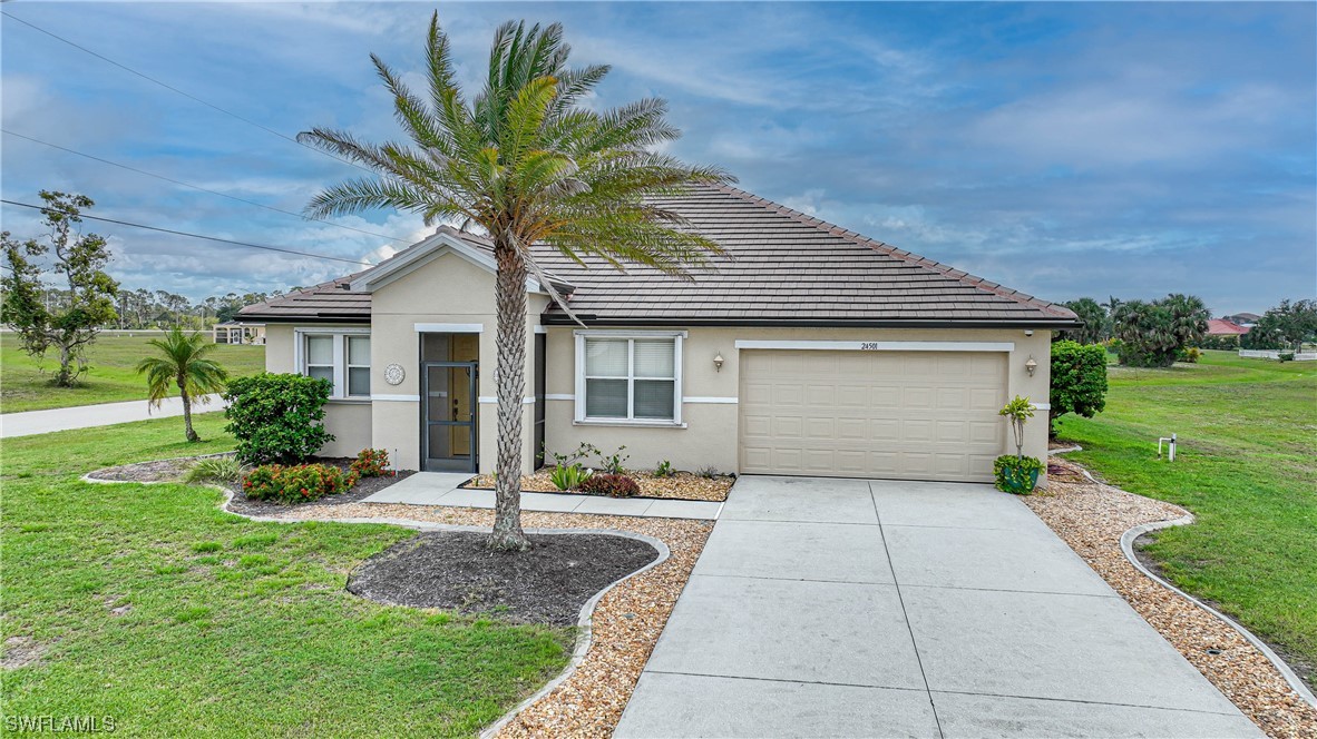 24501 Cabana Road Punta Gorda, FL 33955 - Photo 39 of 39 a front view of a house with a yard and garage
