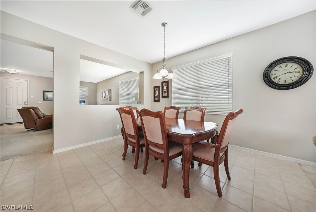 24501 Cabana Road Punta Gorda, FL 33955 - Photo 6 of 39 a view of a dining room that has a table and chairs