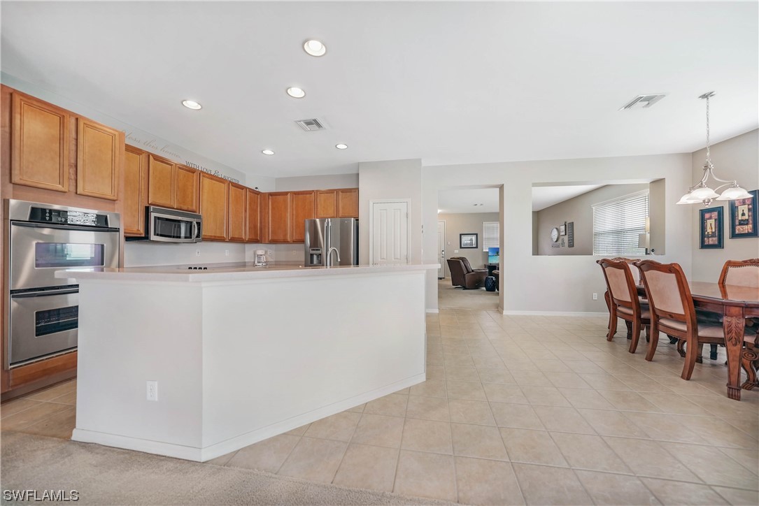 24501 Cabana Road Punta Gorda, FL 33955 - Photo 8 of 39 a kitchen with stainless steel appliances granite countertop a refrigerator and a stove top oven
