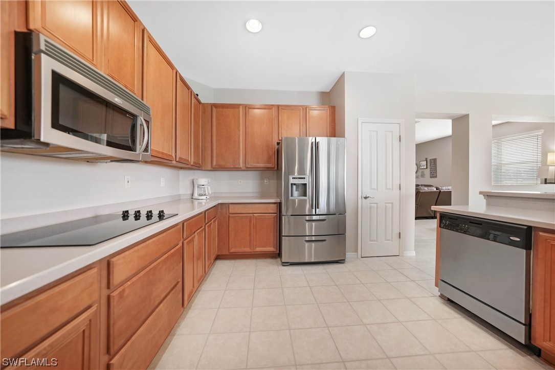 24501 Cabana Road Punta Gorda, FL 33955 - Photo 9 of 39 a kitchen with stainless steel appliances a refrigerator sink and microwave