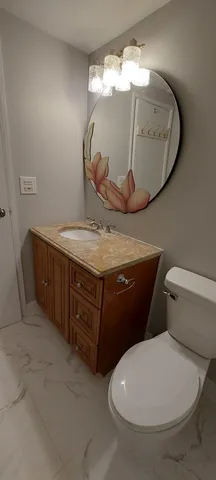a bathroom with a toilet and a mirror