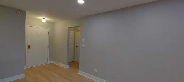 a view of hallway with bathroom