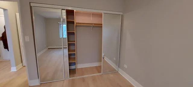 a view of walk in closet with empty racks