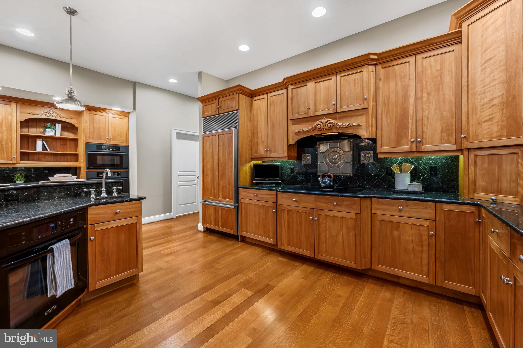 2214 Blue Mt Road Monkton, MD 21111 - Photo 16 of 68 a kitchen with stainless steel appliances granite countertop wooden cabinets a stove a sink and a refrigerator
