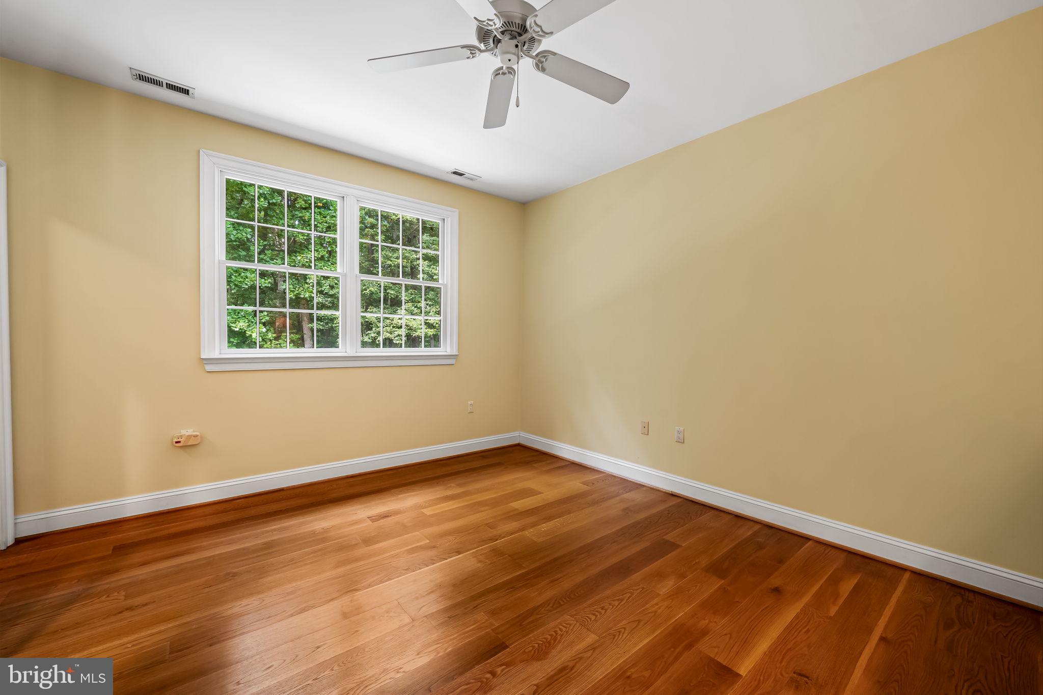 2214 Blue Mt Road Monkton, MD 21111 - Photo 43 of 68 a view of an empty room with wooden floor and a window