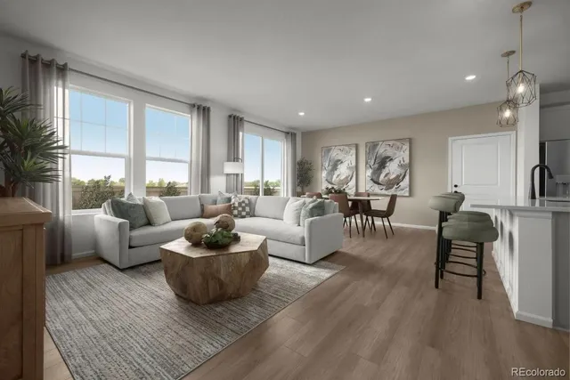 a kitchen with stainless steel appliances a table chairs refrigerator and microwave