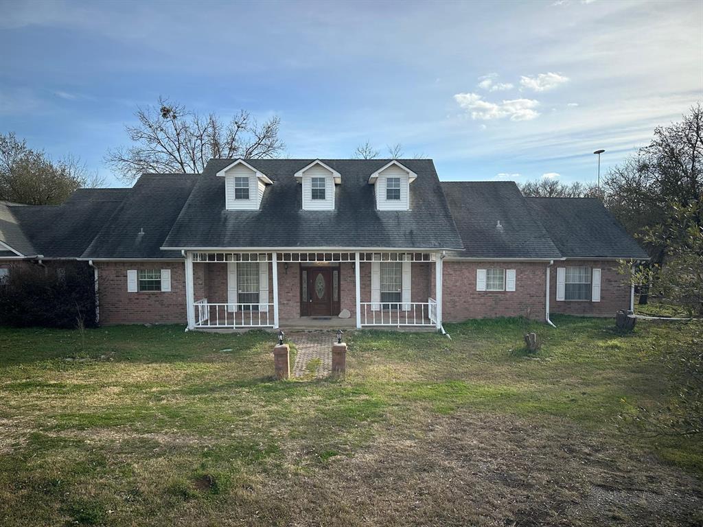 8099 Interstate 30 Frontage Road Cumby, TX 75433 - Photo 1 of 19 a front view of a house with a garden