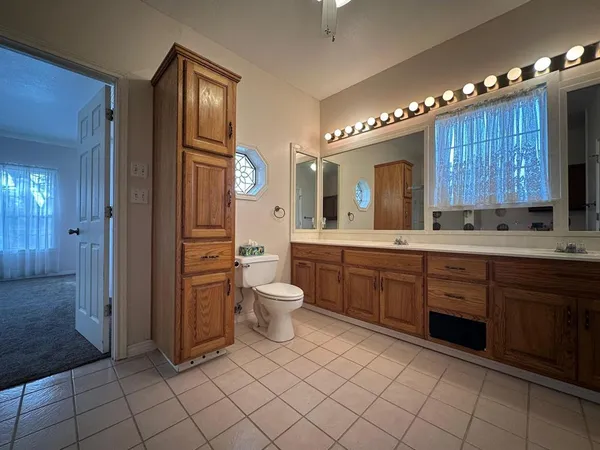 a spacious bathroom with a double vanity sink a mirror and a shower
