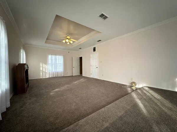 a view of empty room with a ceiling fan and window