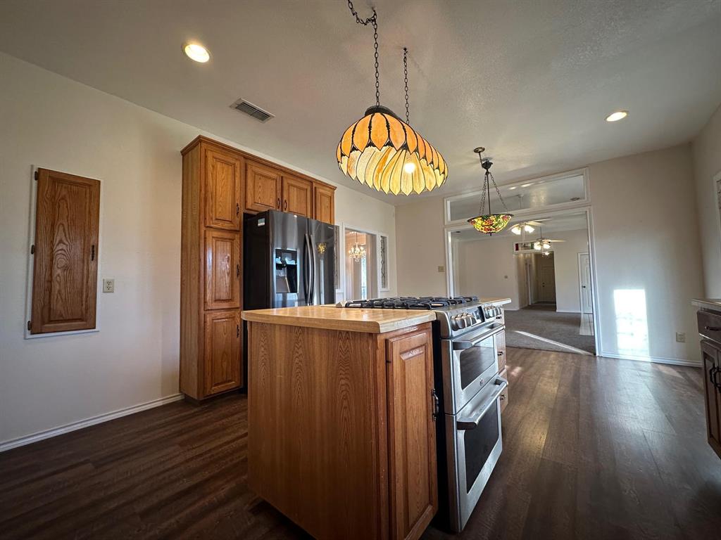8099 Interstate 30 Frontage Road Cumby, TX 75433 - Photo 2 of 19 an open kitchen with wooden floor and large windows