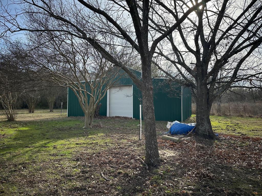 8099 Interstate 30 Frontage Road Cumby, TX 75433 - Photo 4 of 19 a view of a yard with a tree