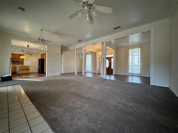 an empty room with entrance and windows