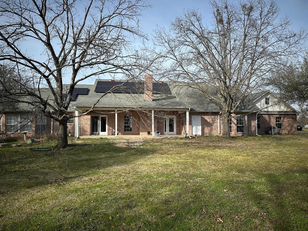 8099 Interstate 30 Frontage Road Cumby, TX 75433 - Photo 7 of 19 a front view of a house with a garden