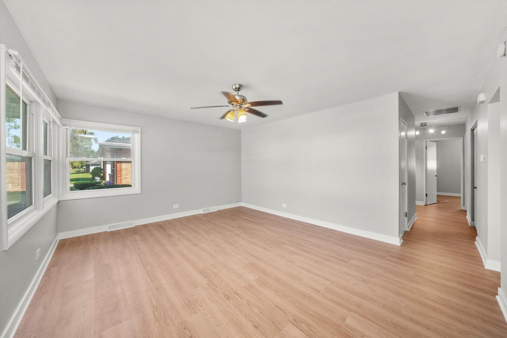 16333 Winchester Avenue Markham, IL 60428 - Photo 4 of 23 a view of a livingroom with wooden floor and a ceiling fan